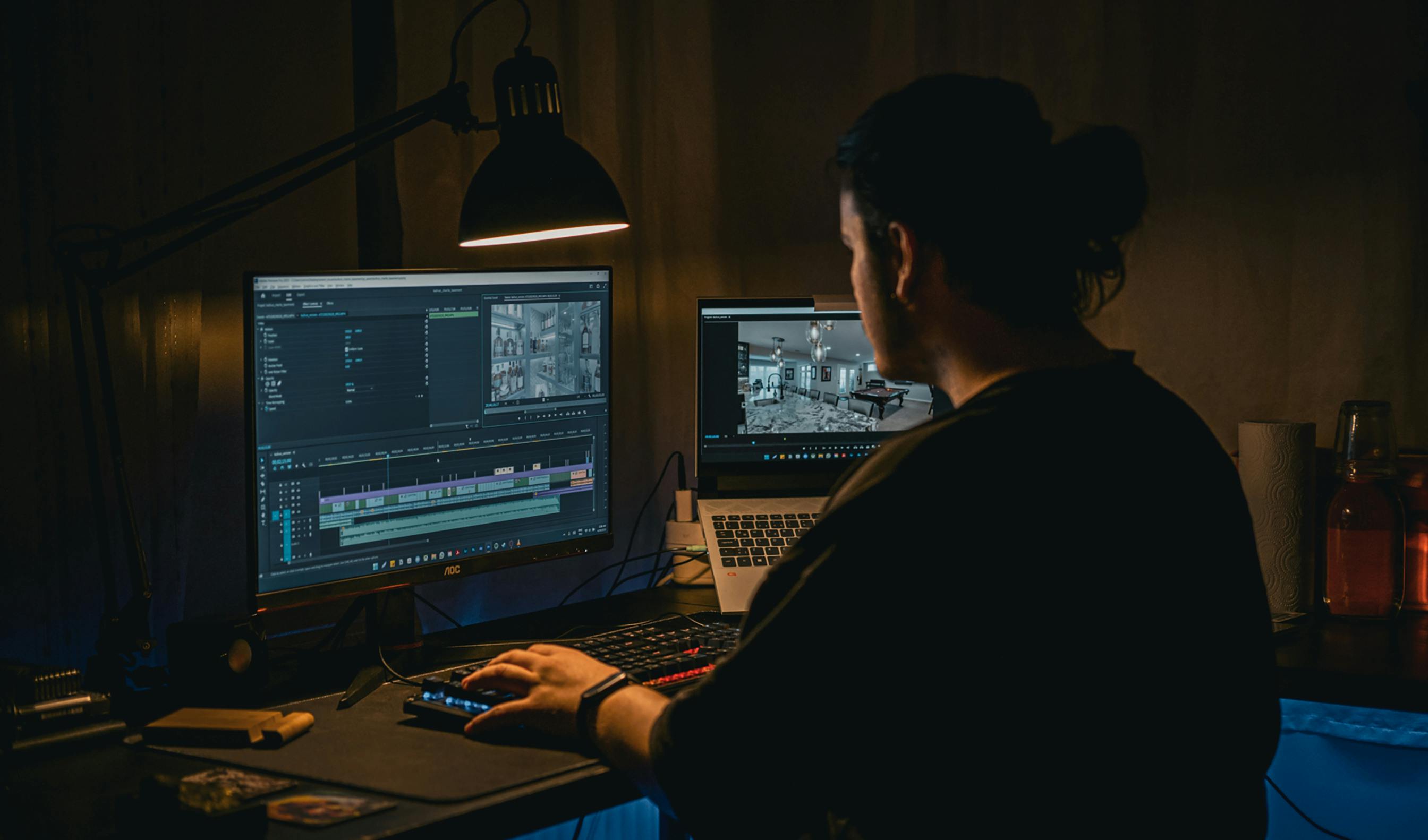 Freelance video editor working at dual monitors