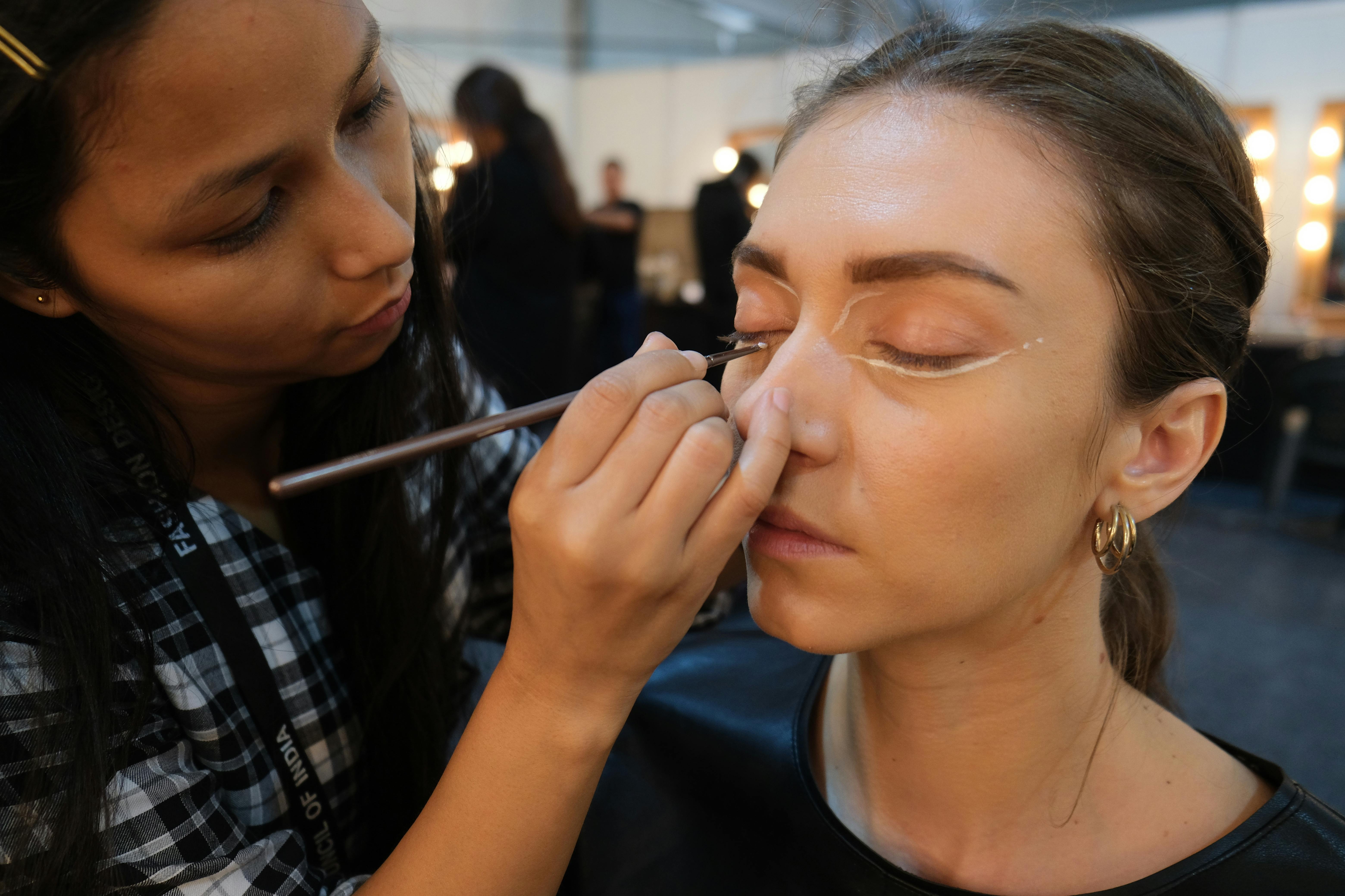 Freelance makeup artist working on set